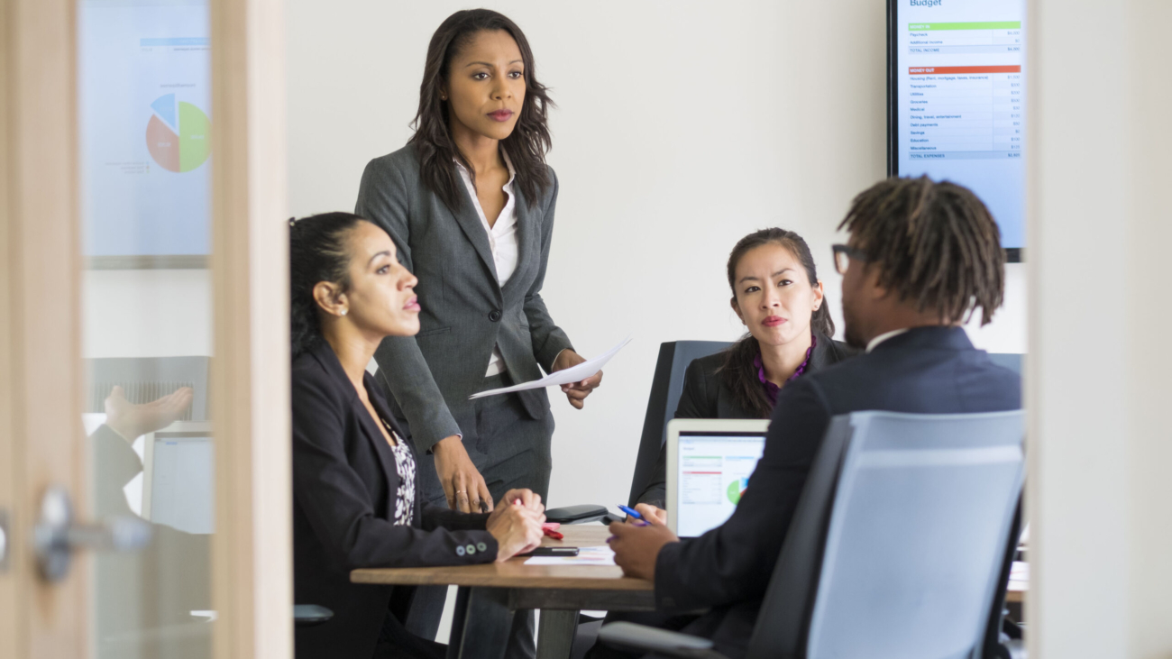 Businessman and businesswomen sitting in office, having discussion