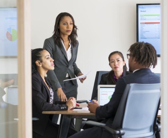 Businessman and businesswomen sitting in office, having discussion
