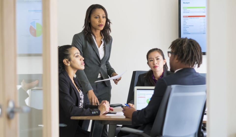 Businessman and businesswomen sitting in office, having discussion